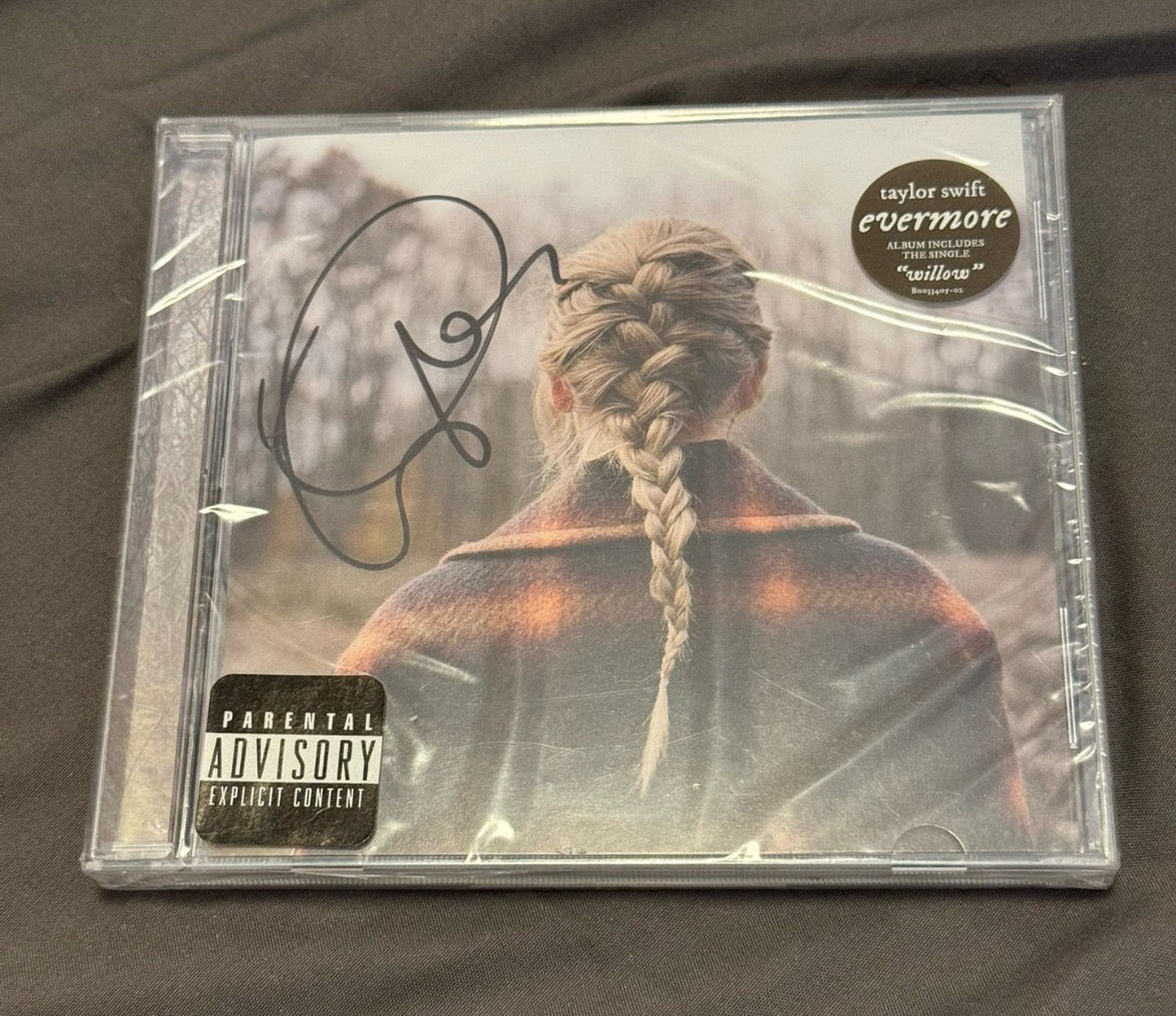 Taylor Swift Evermore CD with a rare, fine-point signature. The CD is in mint condition, and it features a special signature